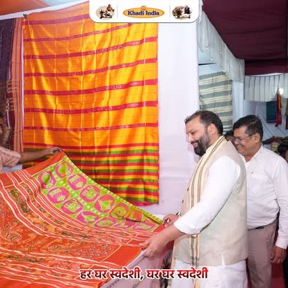 Manoj Goel inspecting Khadi sarees at textile exhibition